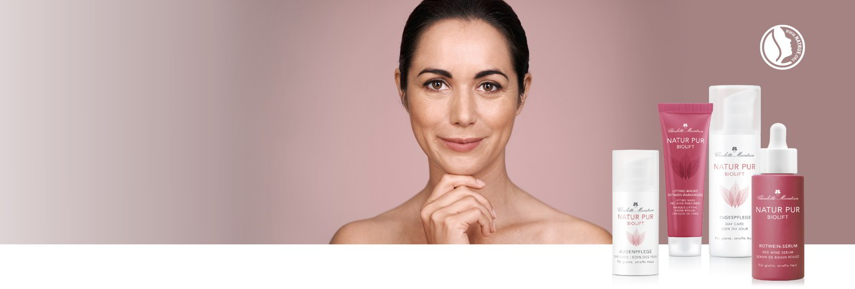 Eine Frau hält ihre Hände an das Gesicht. Im Vordergrund stehen fünf Hautpflegeprodukte aus der Serie NATUR PU BIOLIFT in verschiedenen Behältern.