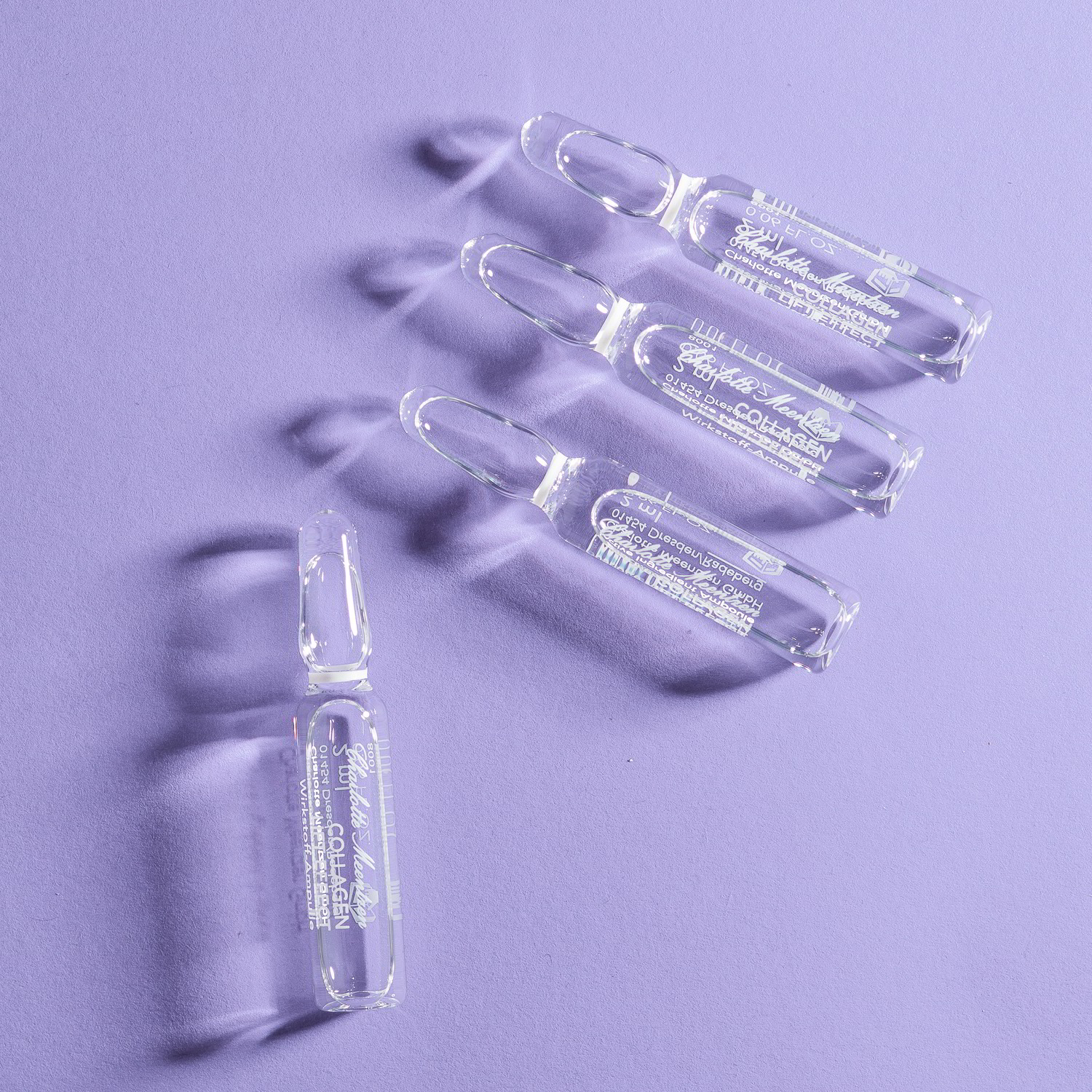 Clear ampoules of collagen lift on purple background